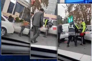 The traffic police inspector breaks the window of the car and pulls the driver out